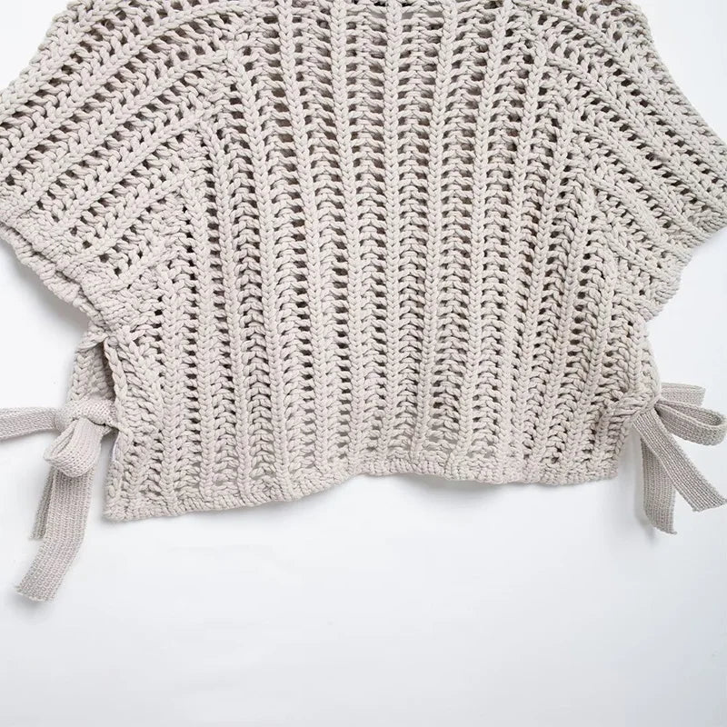 Crocheted beige top with tied sleeves on a white background