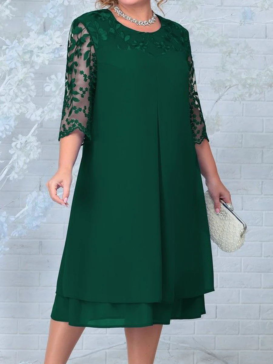 Green dress with lace sleeves on a textured white background
