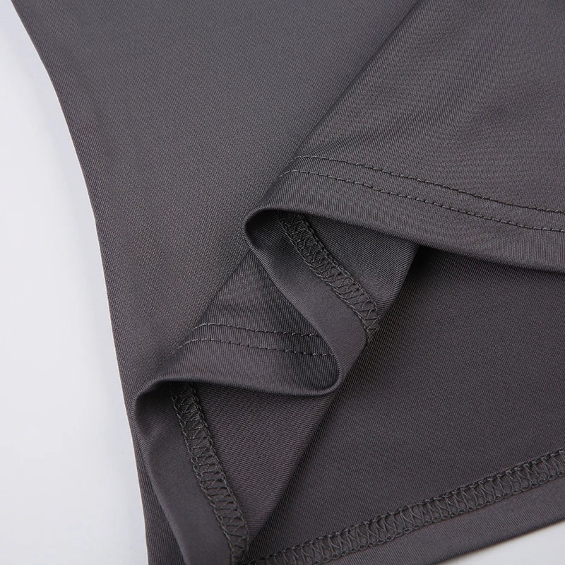Close-up of gray fabric with stitching detail on a white background