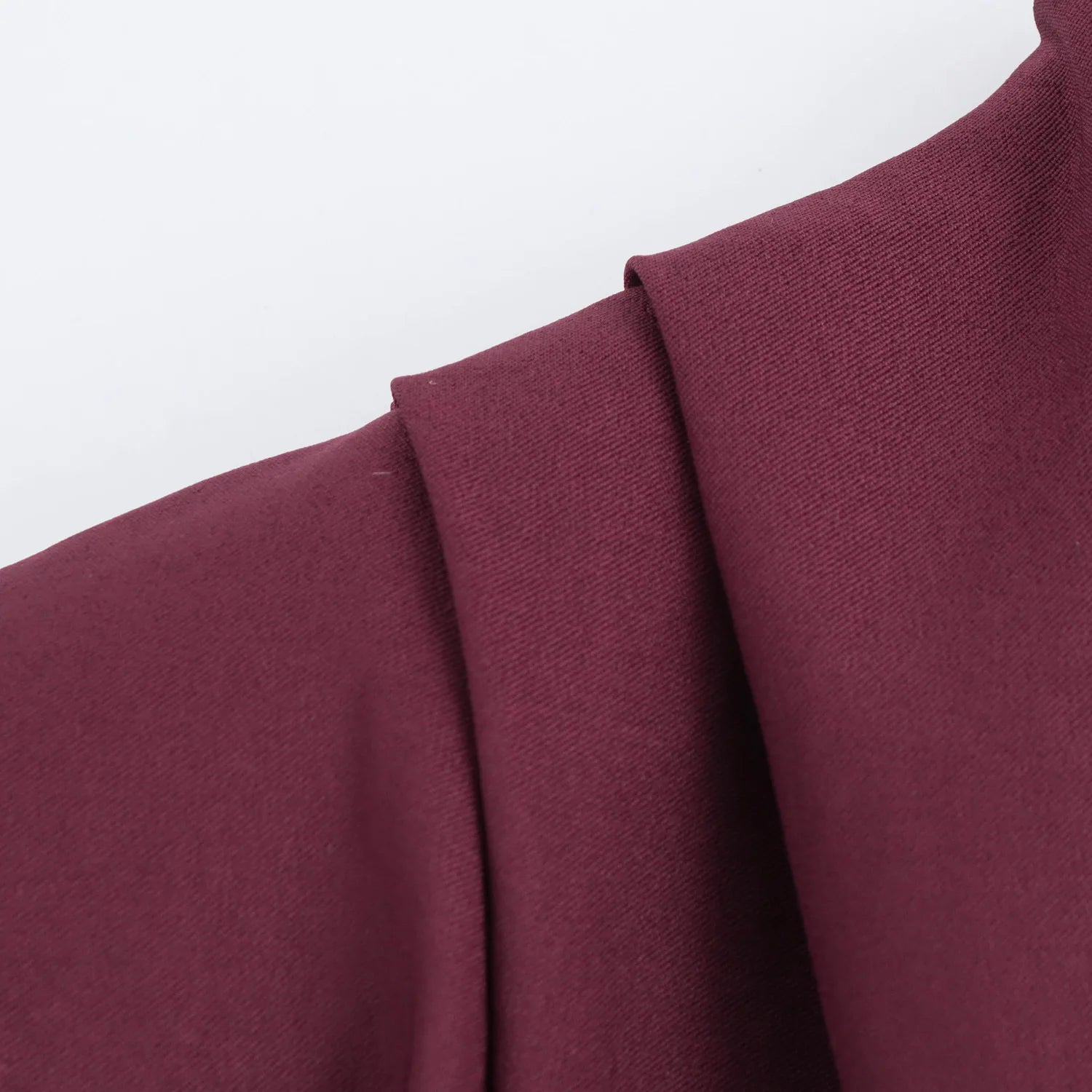 Close-up of a burgundy fabric with a plain background