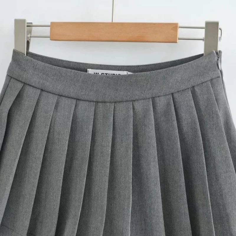 Gray pleated skirt on a hanger against a white background