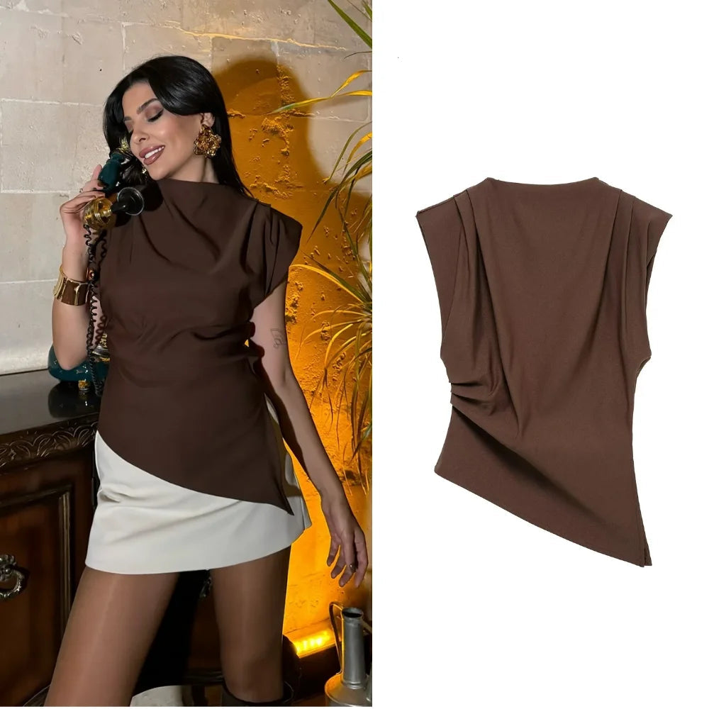 Woman wearing a brown top and white skirt with a decorative background, featuring the brand 'SARASEY'.