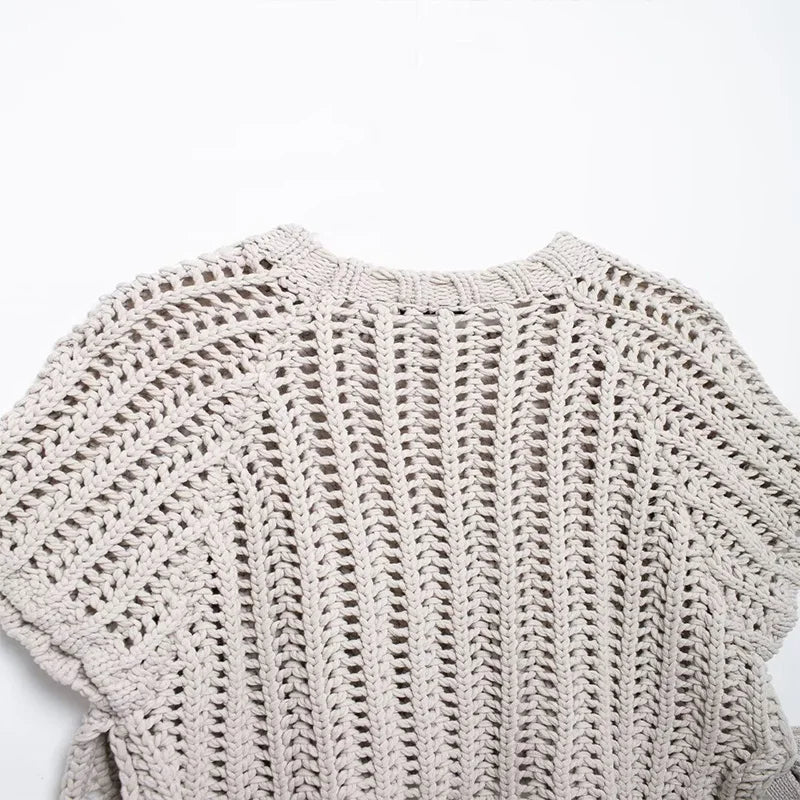Close-up of a textured beige sweater on a white background