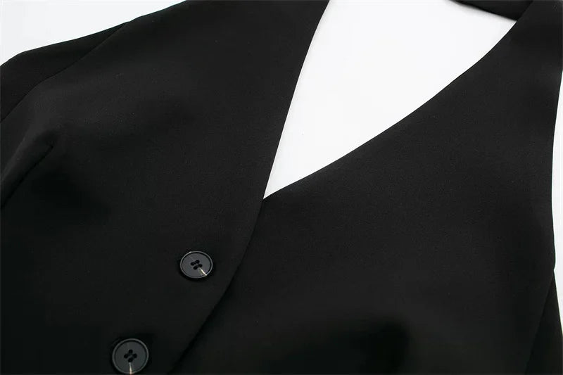 Close-up of a black blazer with buttons on a white background