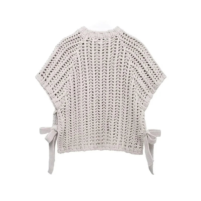 Crocheted top with bow details on a white background
