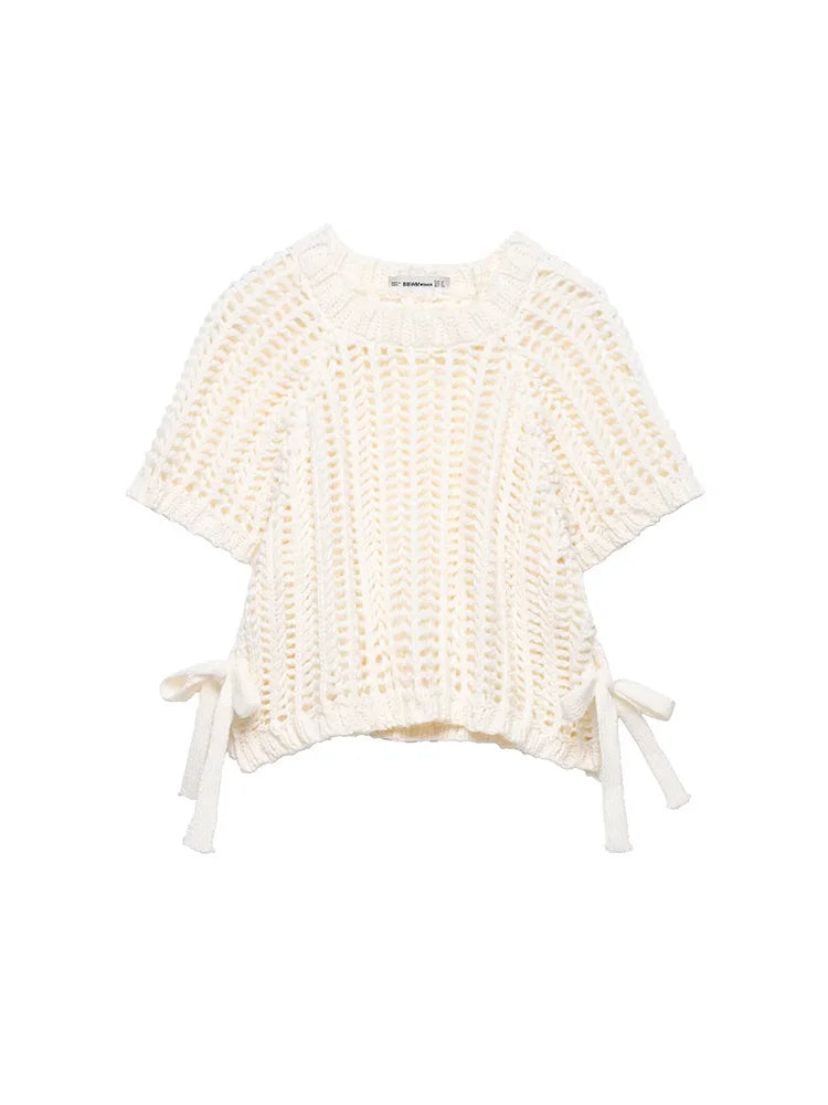 White knitted top with tassels on a white background