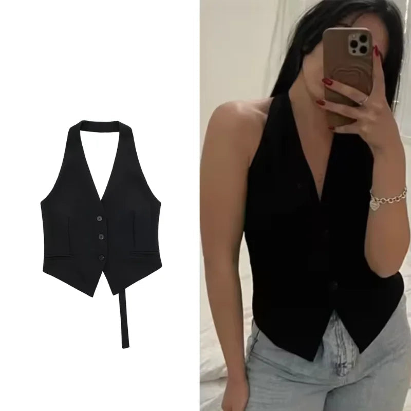 Black vest on a white background, worn by a person.