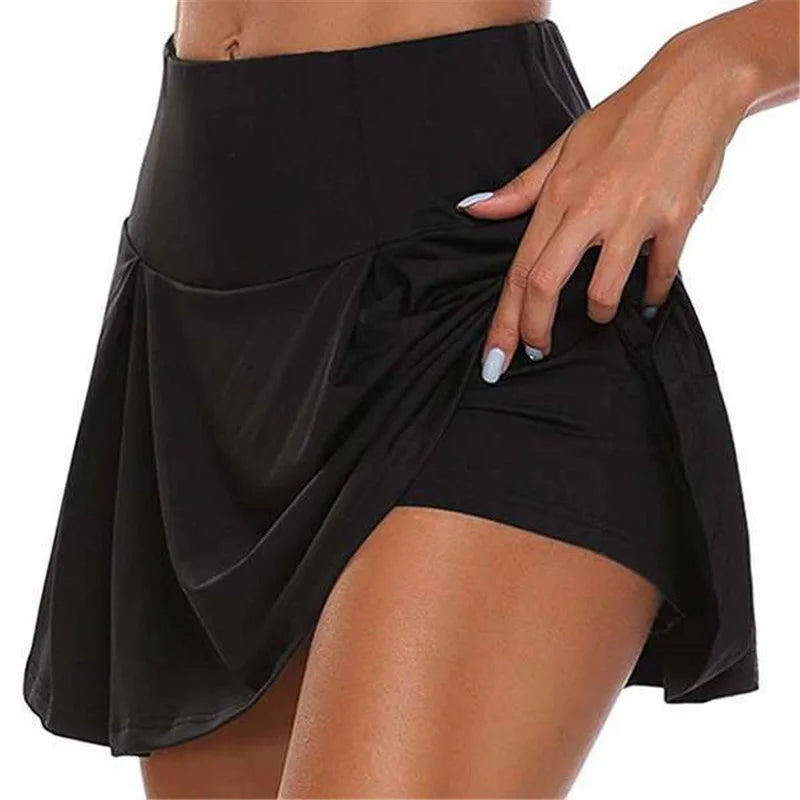 Black athletic skirt worn by a person on a white background