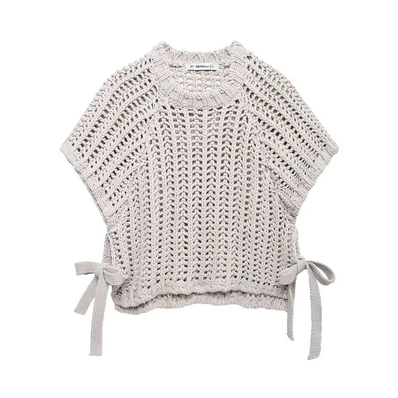 Crocheted top with tie details on a white background