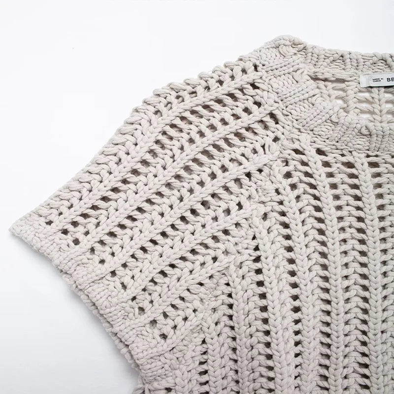 Close-up of a textured beige fabric with a subtle pattern on a white background